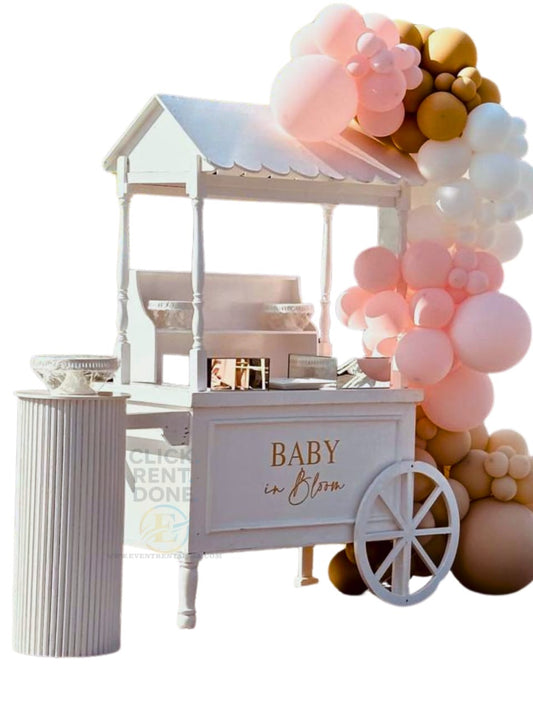 White baby shower cart with balloons and 'Baby in Bloom' text on a white background